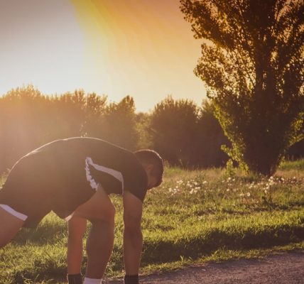 a person bending over on a road