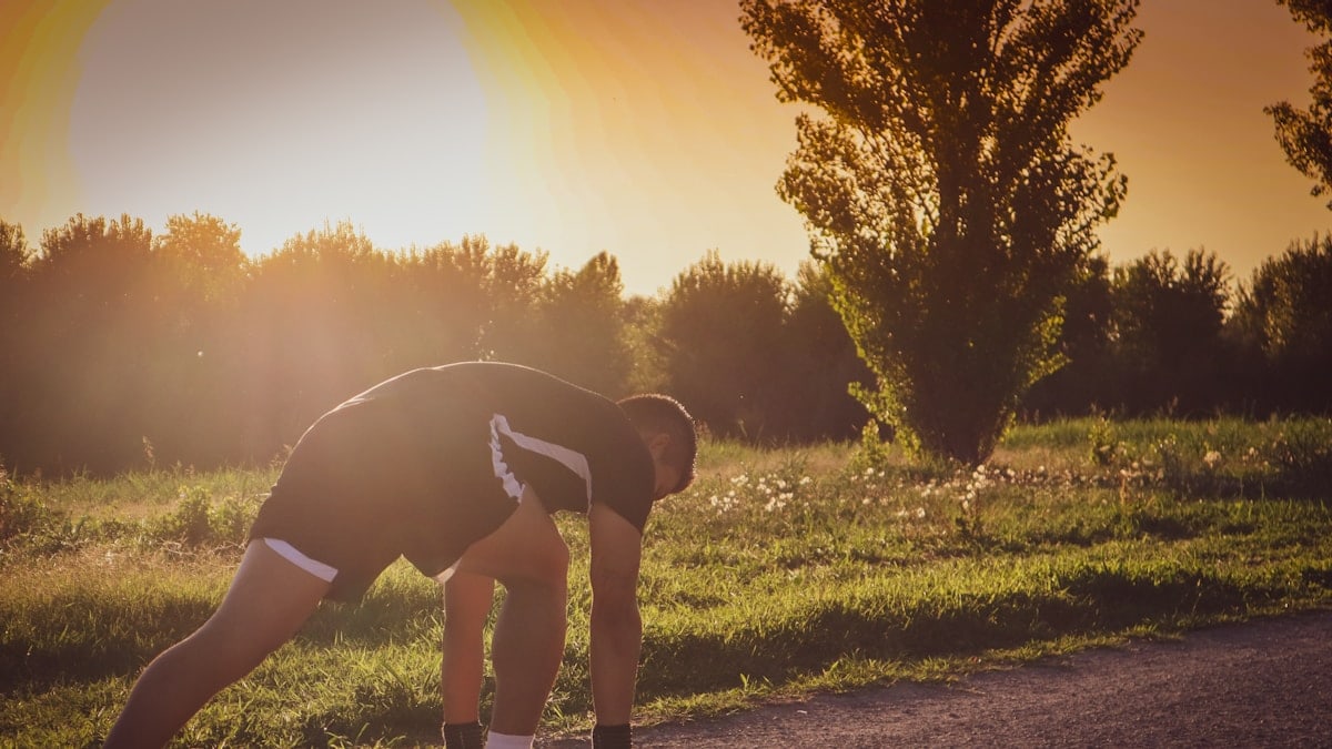 a person bending over on a road